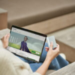 a person sitting at a table using a laptop