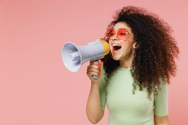 A woman shouting in a megaphone about referral programs for smbs