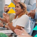 A diverse group of professionals enthusiastically applauding during a sales meeting, embodying sales motivation.