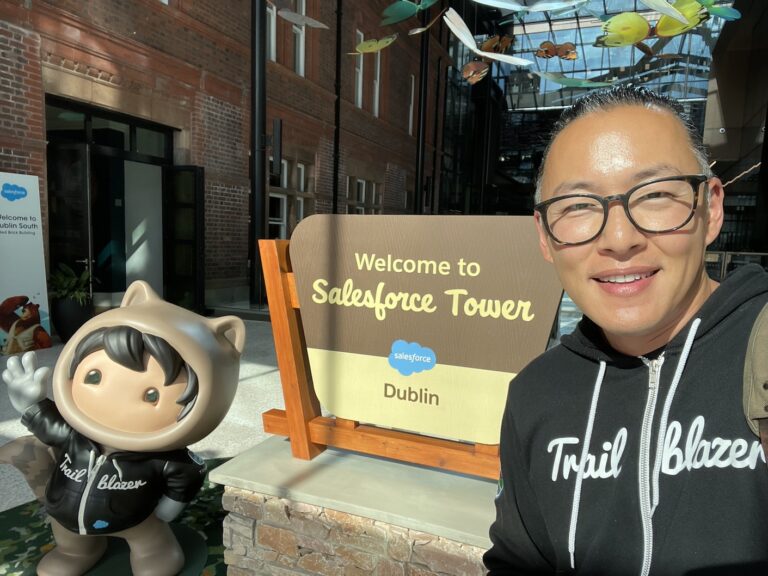 Daniel poses with the "Welcome to Salesforce Tower Dublin" sign and Astro statue