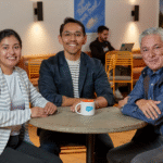 Three Salesforce employees spending time together in a cafeteria.