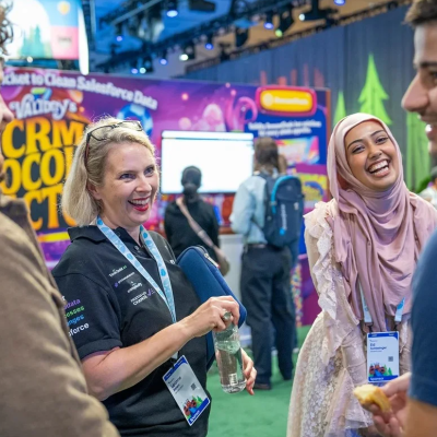 Attendees at Dreamforce sharing a moment of connection for networking small businesses.