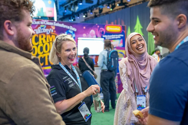 Attendees at Dreamforce sharing a moment of connection for networking small businesses.